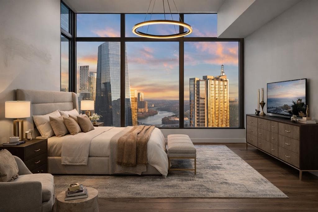 Floor-to-ceiling skyline and river views from an upper-floor Fifth & West residence at dusk